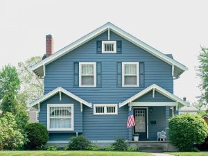 The exterior of a two-story home with blue paint.