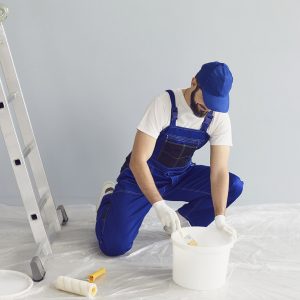 Bearded Worker Painter Taking Paint From Bucket